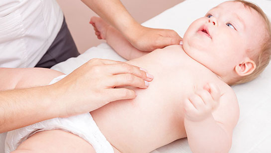 Baby receiving chiropractic adjustment to relieve colic from Cary chiropractor