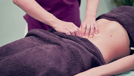 Woman receiving myofascial release for fertility from Cary chiropractor