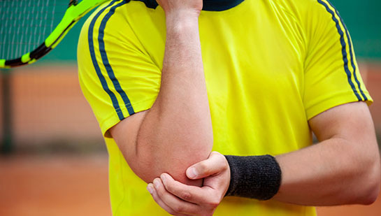 Man with tennis elbow before chiropractic treatment from Cary chiropractor