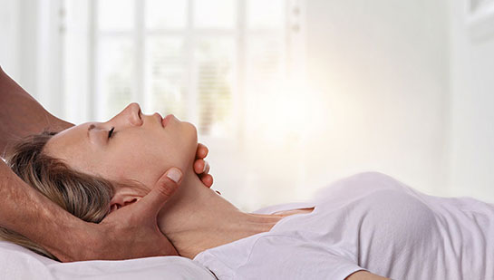 Woman receiving neck adjustment from Cary chiropractor