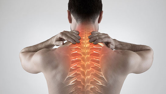 Man with upper back pain before chiropractic treatment from Cary chiropractor