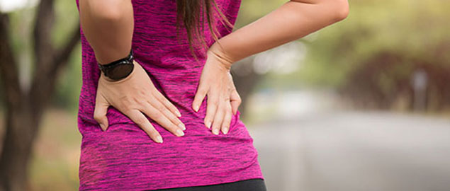 Woman suffering from low back pain Cary