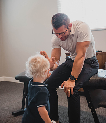 Patient receiving pediatric chiropractic in Cary for pain relief